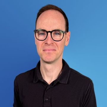 a picture of Brian Crook in blue background