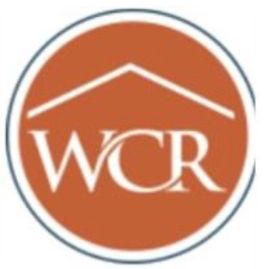 Orange circular WCR logo with white roof line and lettering, outlined in gray.