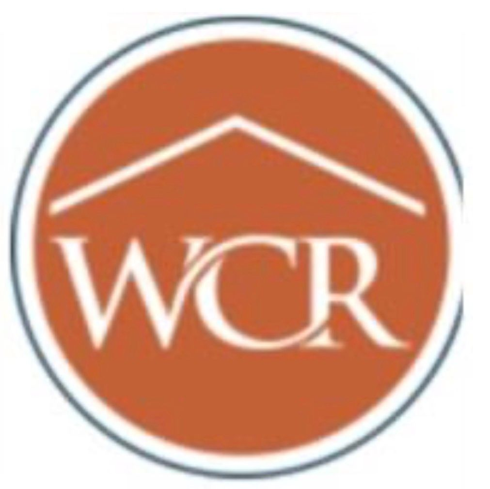 Orange circular WCR logo with a white roofline and gray border