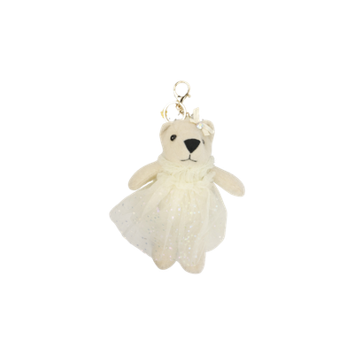 Een crèmekleurige pluche beer als sleutelhanger, met een glinsterend wit tule rokje en een bijpassende haarstrik.