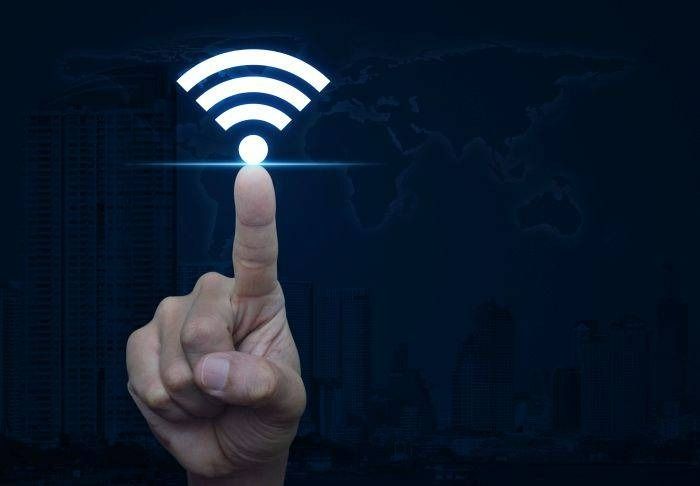 Finger Touching Glowing Wi‑fi Symbol — Austec IT & CCTV in Beerwah, QLD