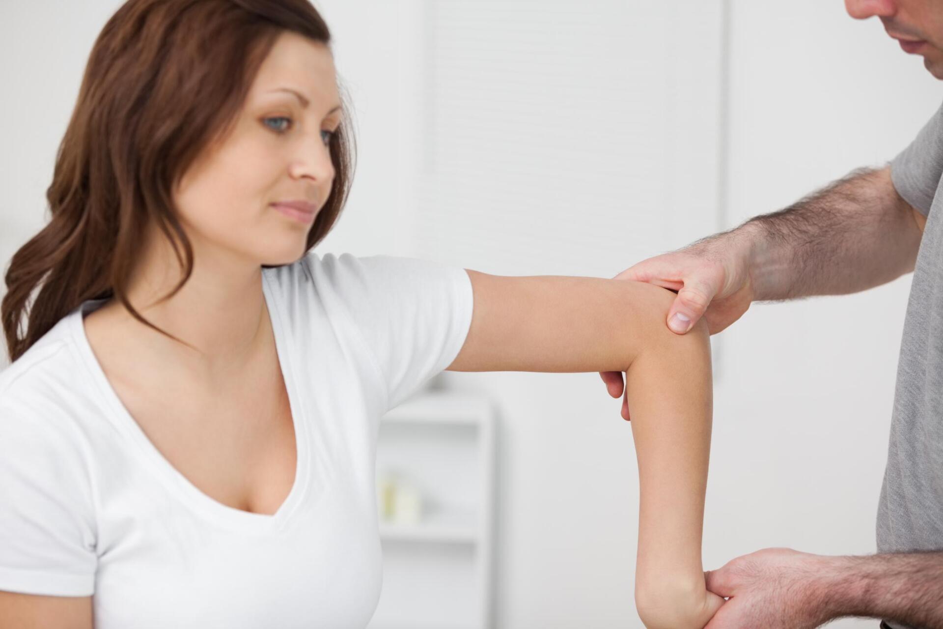 therapist checking the womans arms