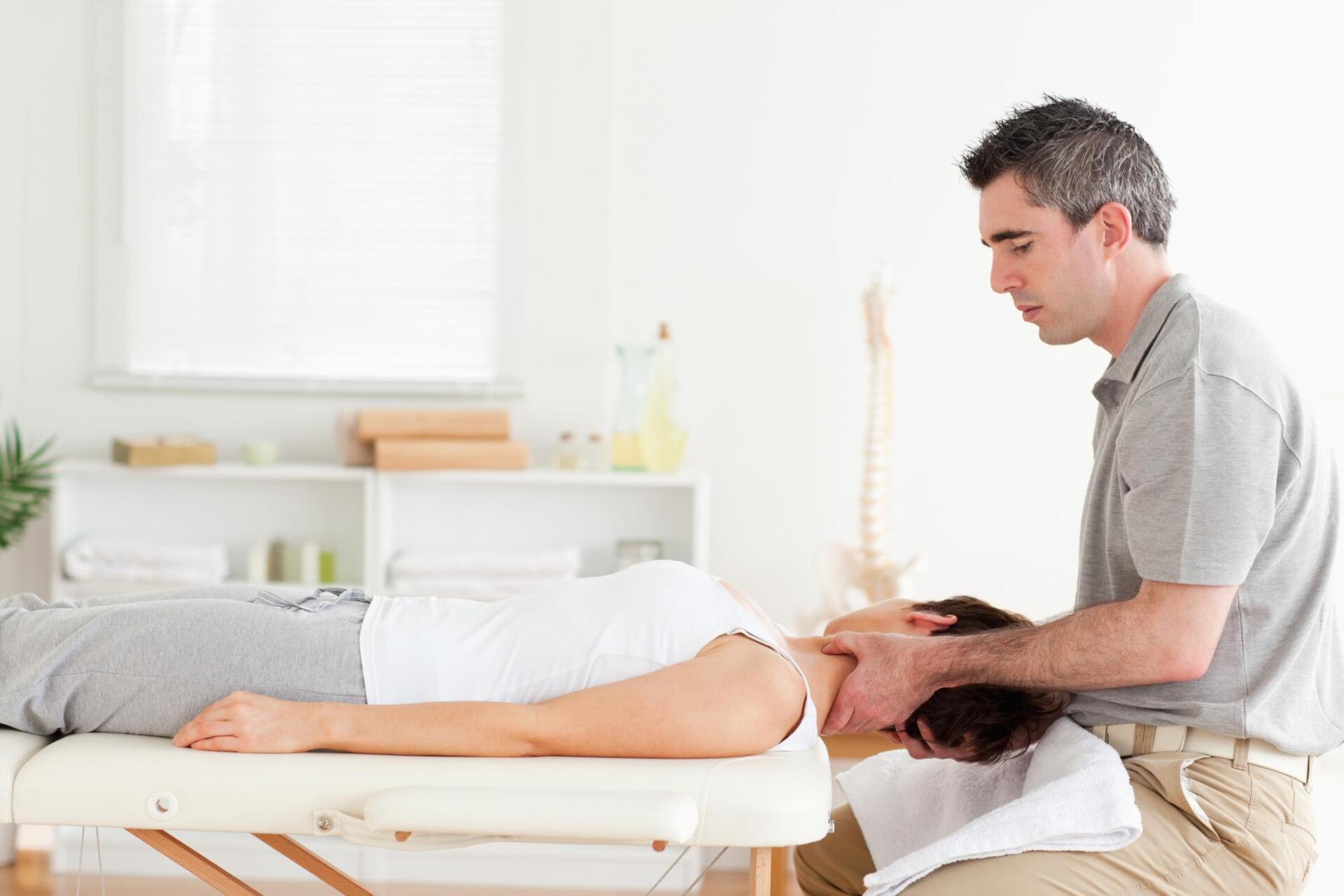 man massaging the womans neck
