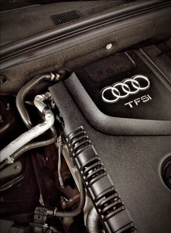 Audi TFSI engine bay with hoses and black plastic cover