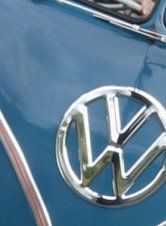 Close-up of a Volkswagen logo on a blue car body