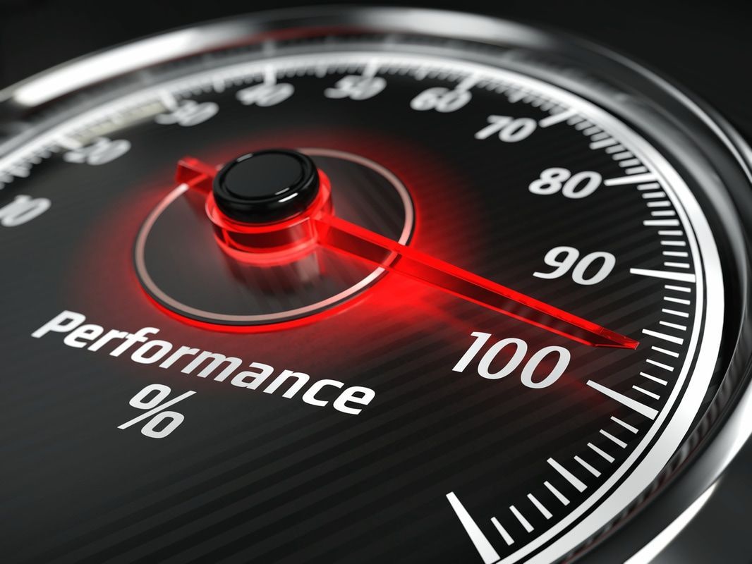 Red performance gauge needle near 100% on a black dial with red glow