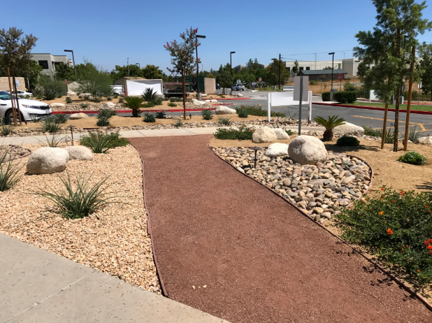Green grass with a square stone pattern walkway.