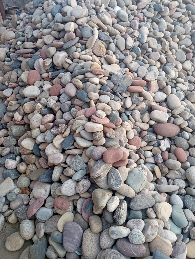 A pile of rocks is sitting on the ground.