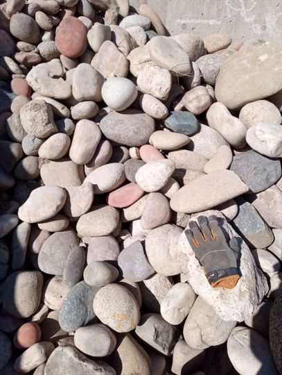 A pile of rocks sitting on top of a gravel road.