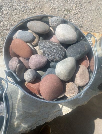 A pile of rocks sitting on top of each other on the ground.