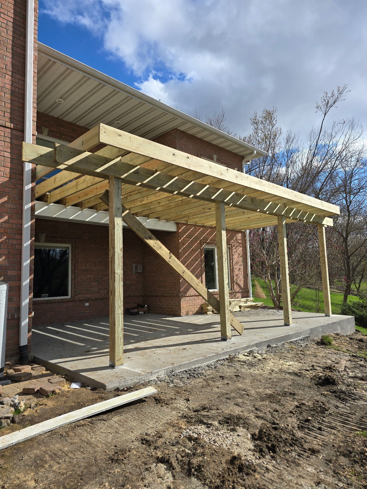 Newly remodeled 500 sq. ft. deck with modern railing and a covered patio below, completed by AMC Homes – Remodeling Contractor in Dubuque