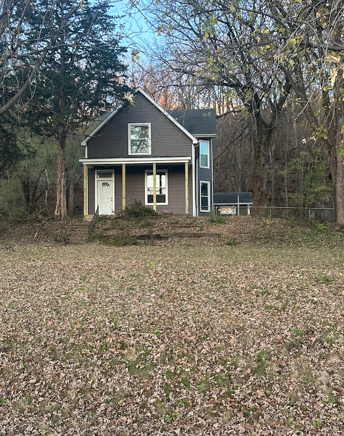 Front view of the beautifully remodeled Elm St home, featuring modern curb appeal, and a welcoming entrance.