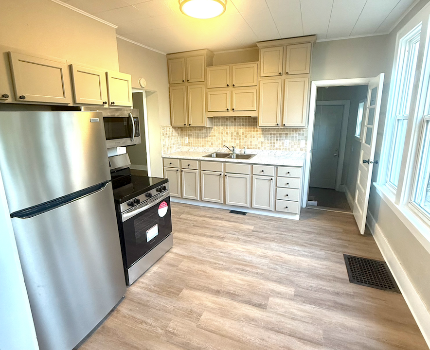 Modern kitchen remodel with new cabinets, countertops, and stainless steel appliances