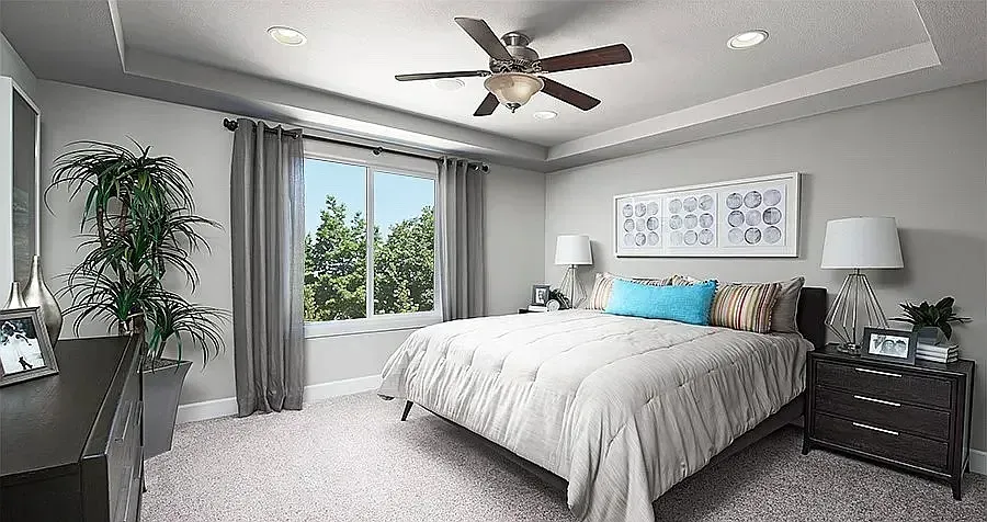Bedroom with bed, dresser, window, plants, and ceiling fan. Gray and white color scheme.