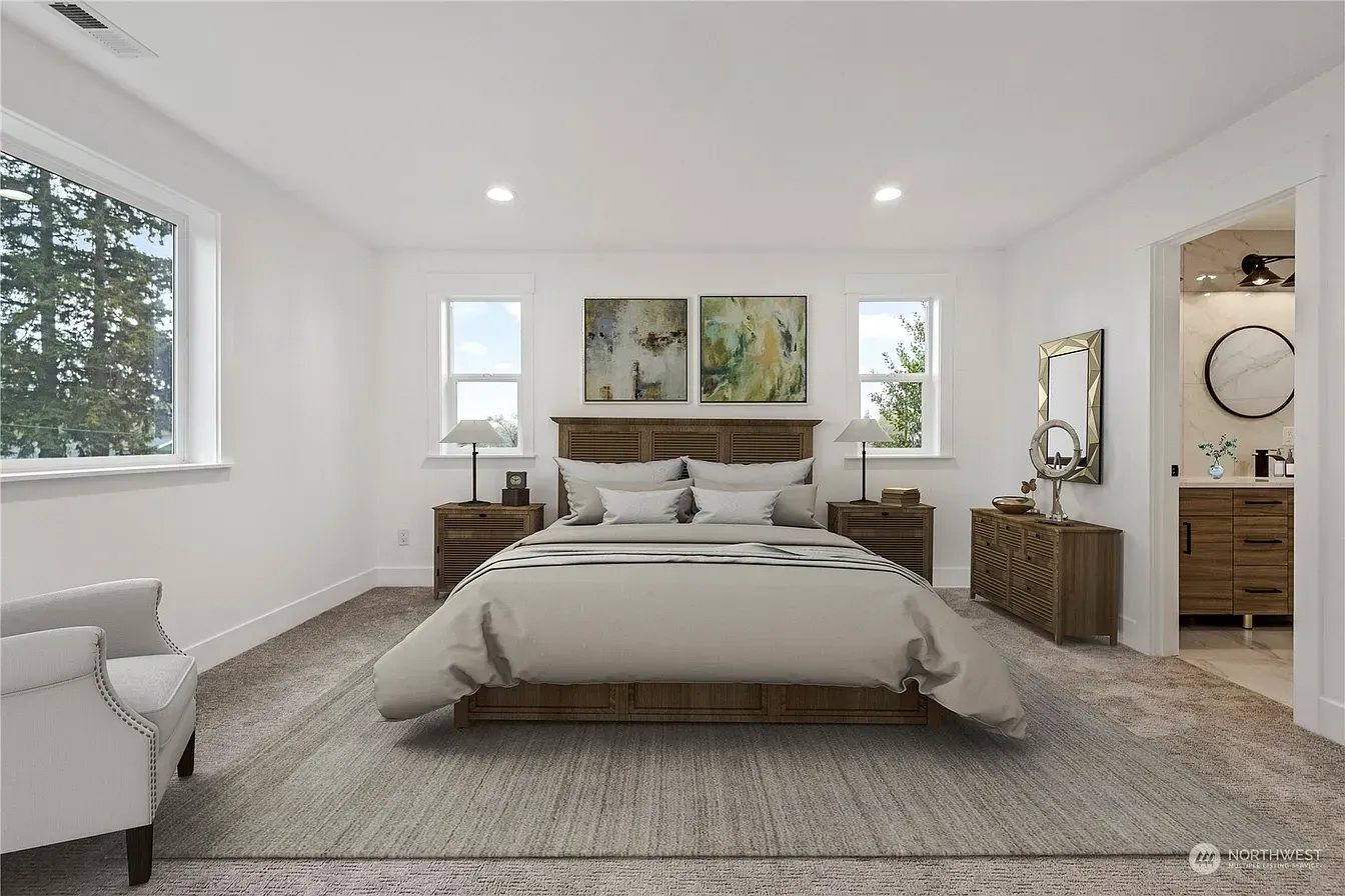 Spacious bedroom with a bed, nightstands, and a door to a bathroom. Light color scheme.
