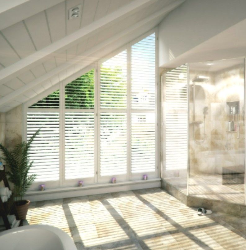 Custom angled plantation shutters installed on a sloped attic bathroom window