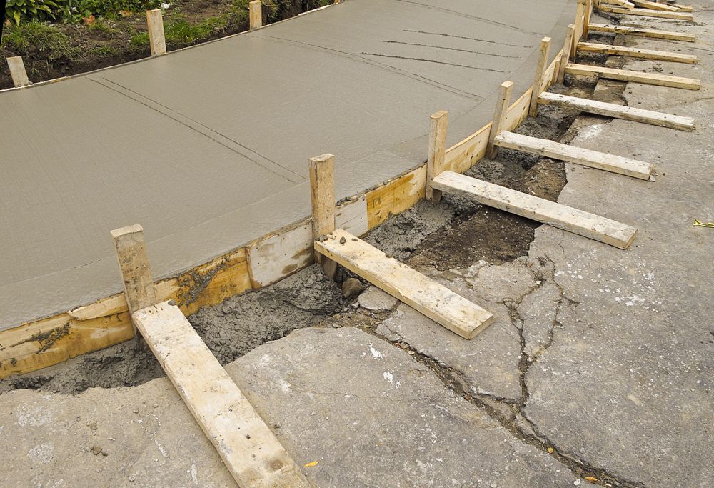 Freshly Poured Concrete Sidewalk With Wooden Forms, in an Urban Setting — Salisbury Concrete Contractors In Lennox Head, NSW