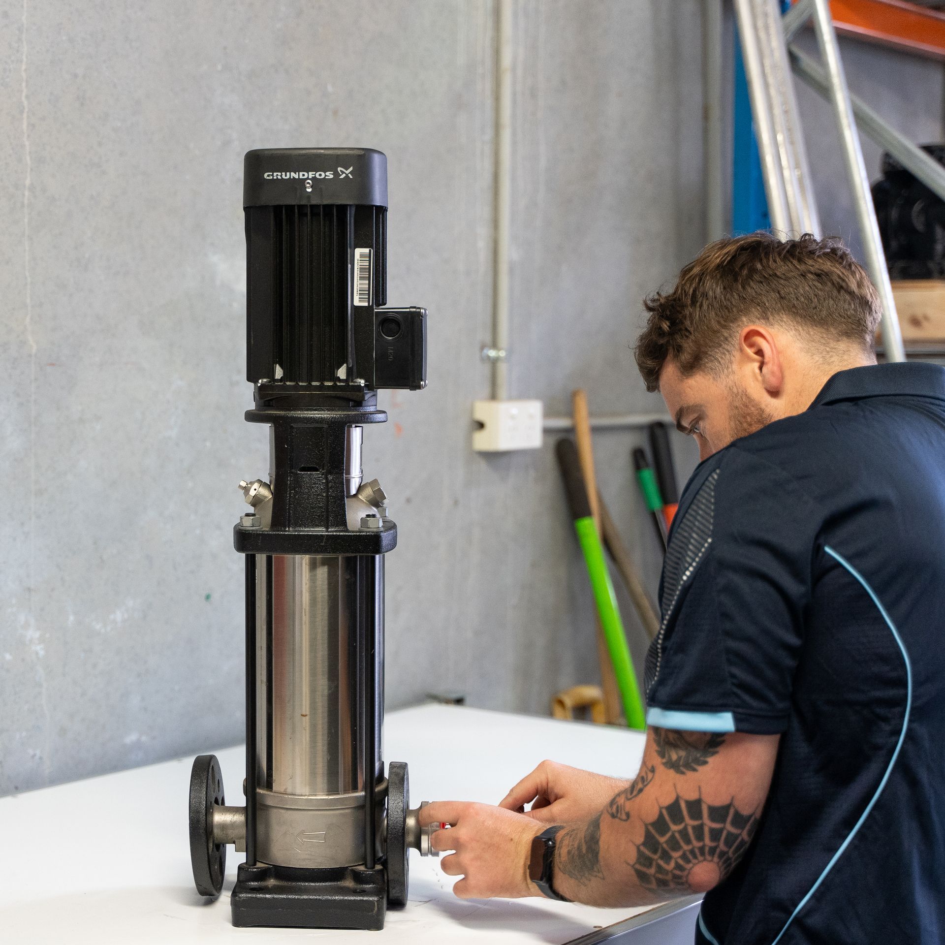 an SC Pumps team member working on a water pump