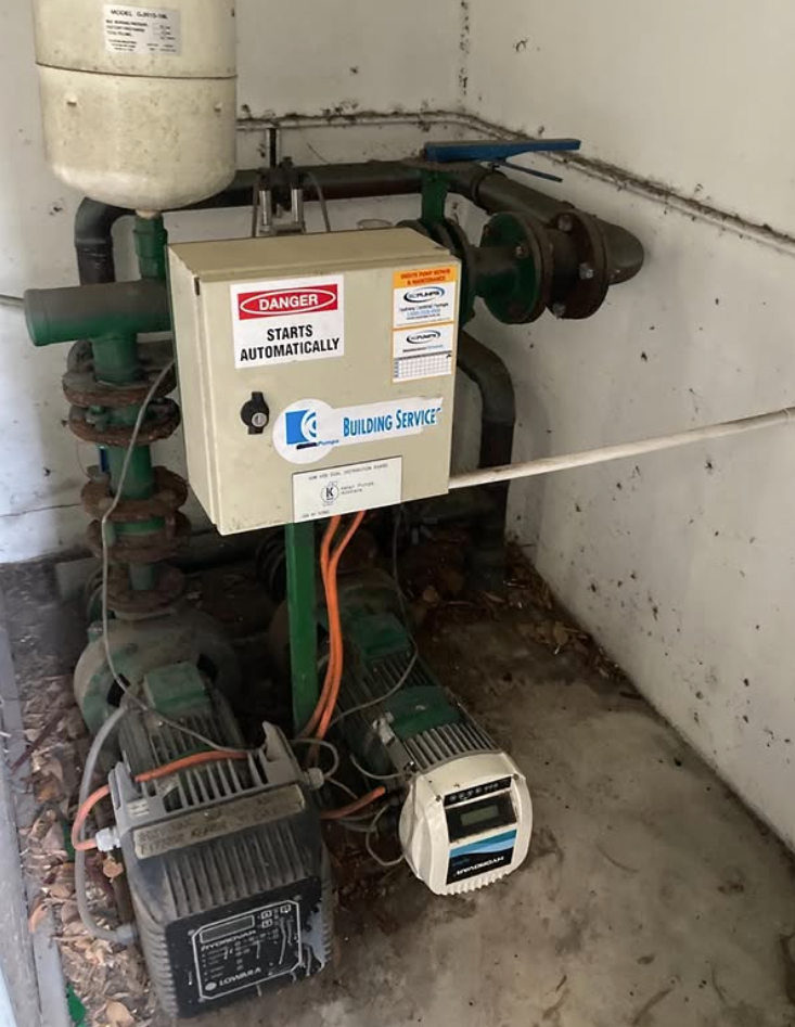 Pump control panel and pressure tanks during a maintenance visit