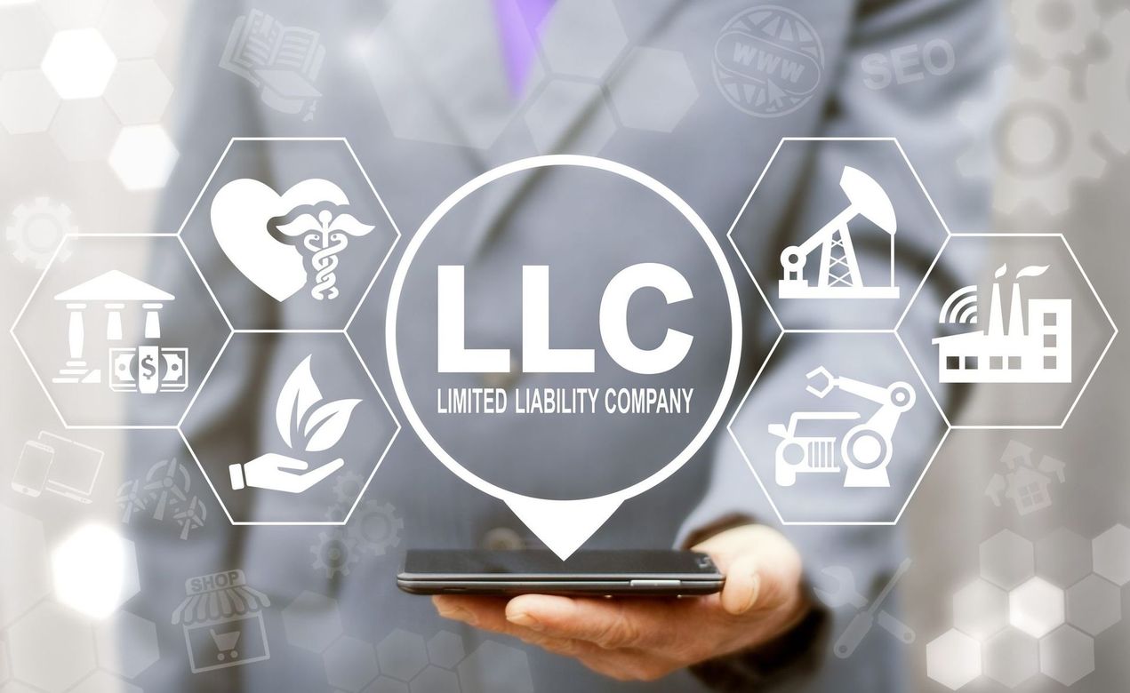 Person holding smartphone with a central LLC icon and surrounding business-related icons.