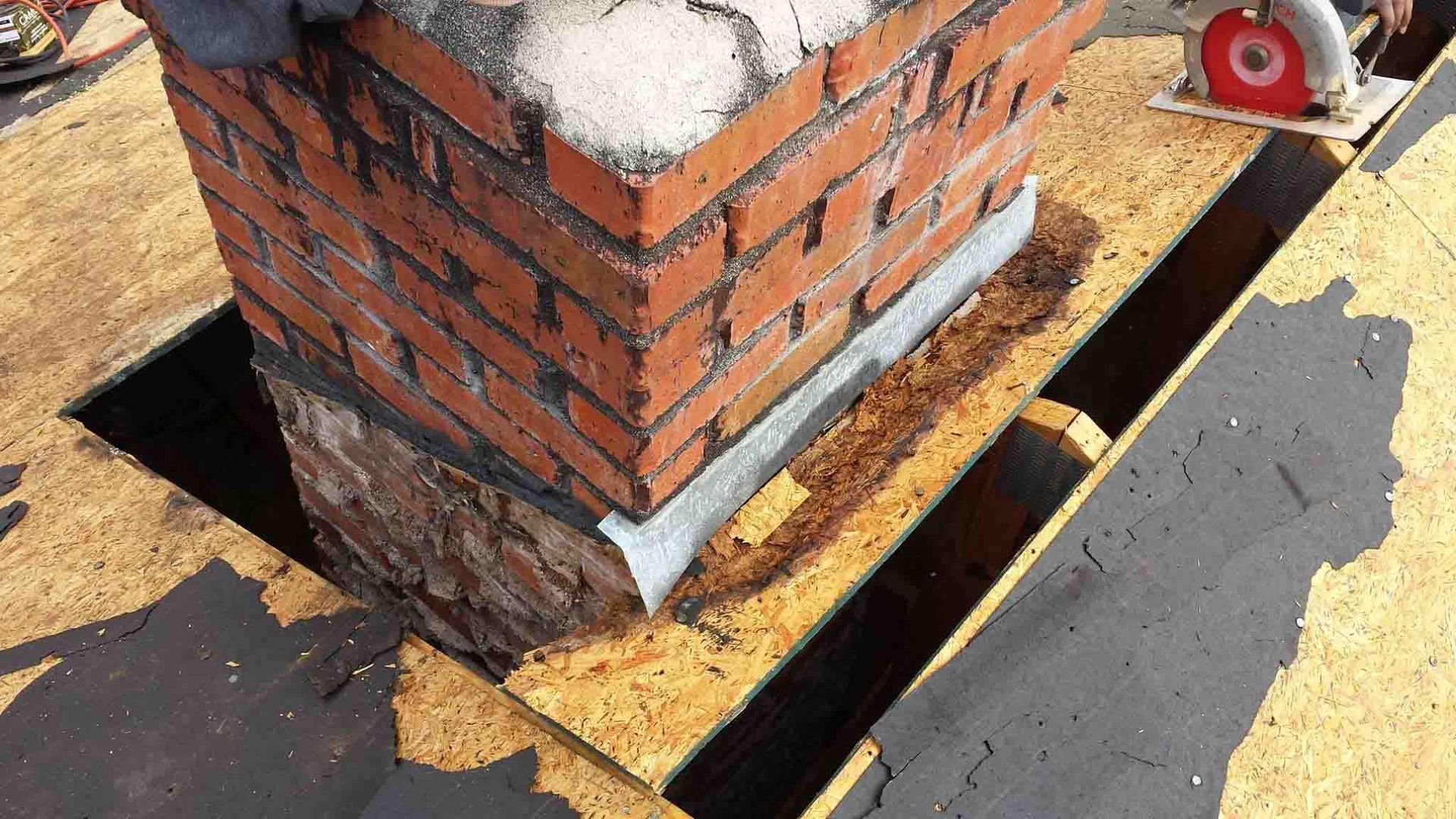 removing old wood of chimney flashing