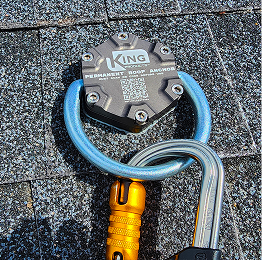 Blue rope looped through a metal rooftop anchor on gray shingles