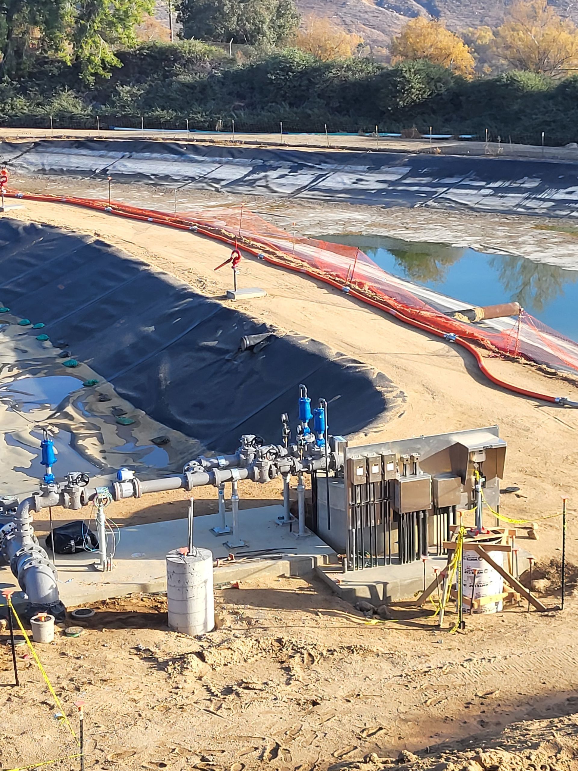 5D Company llc an aerial view of a construction site with a large body of water in the background