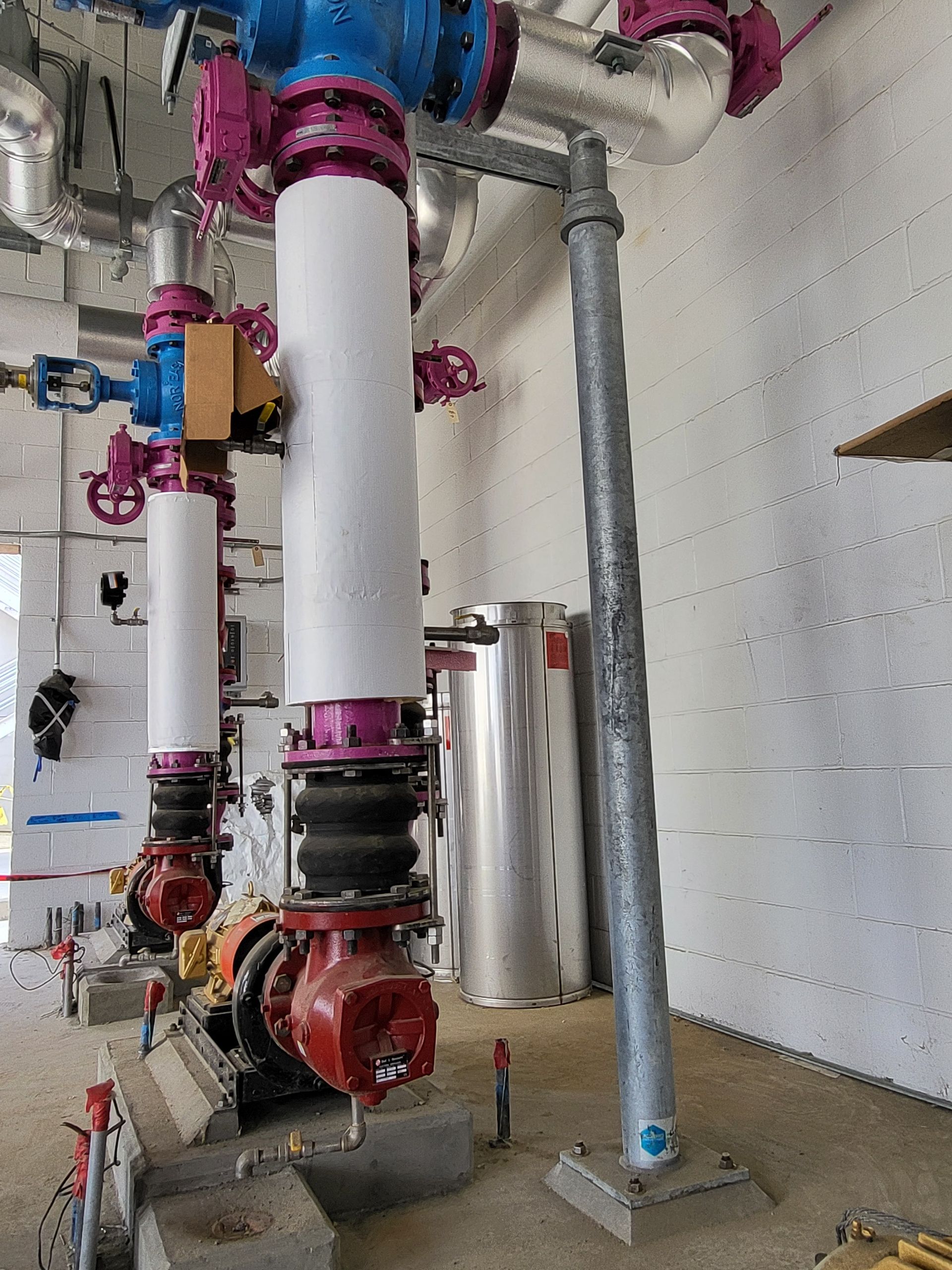 5D Company llc a room filled with lots of pipes and valves .