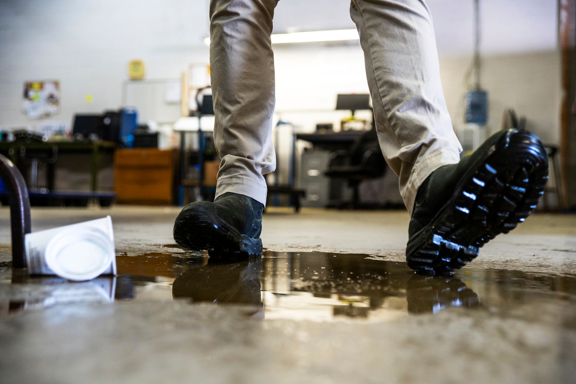Warehouse worker slipping on liquid, requiring a trip and fall attorney