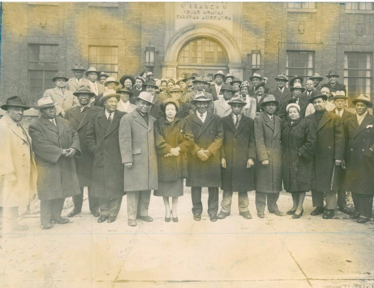 A group of people standing in front of a building that says ' freedom ' on it