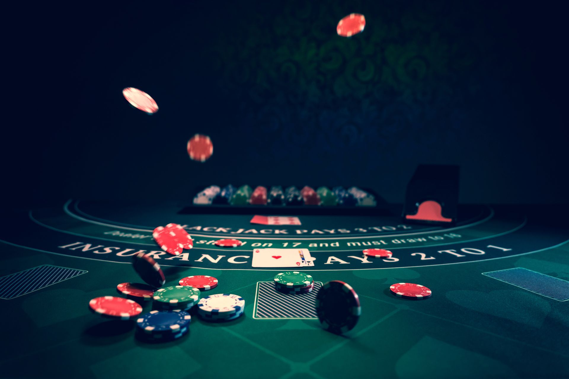 Casino poker table with green felt, scattered chips, cards, and chips flying in the air