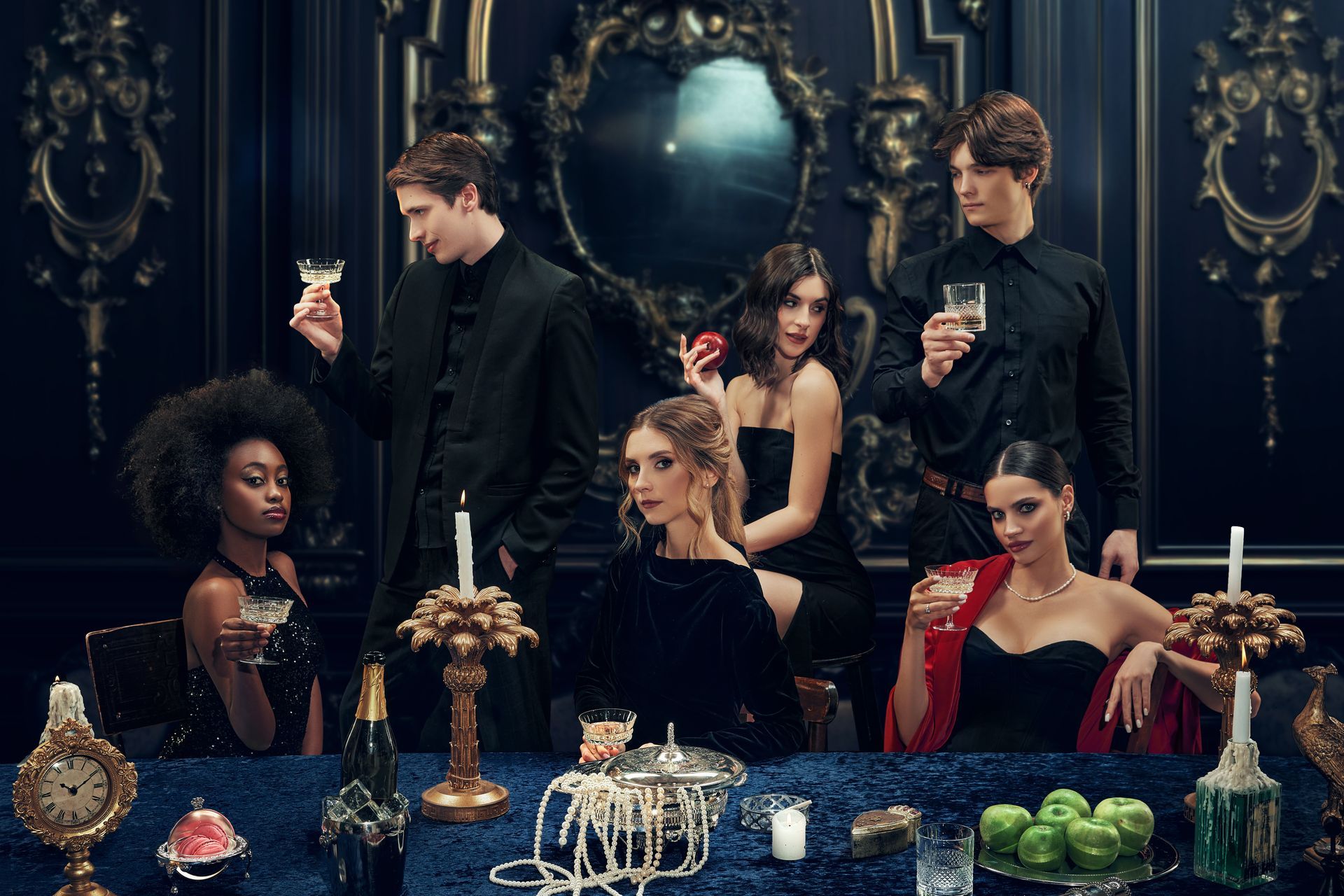 Elegant dinner party with five people in dark formalwear around a candlelit table, ornate decor behind them.