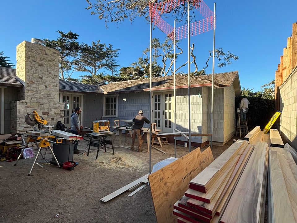 A ladder is sitting in front of a house under construction.