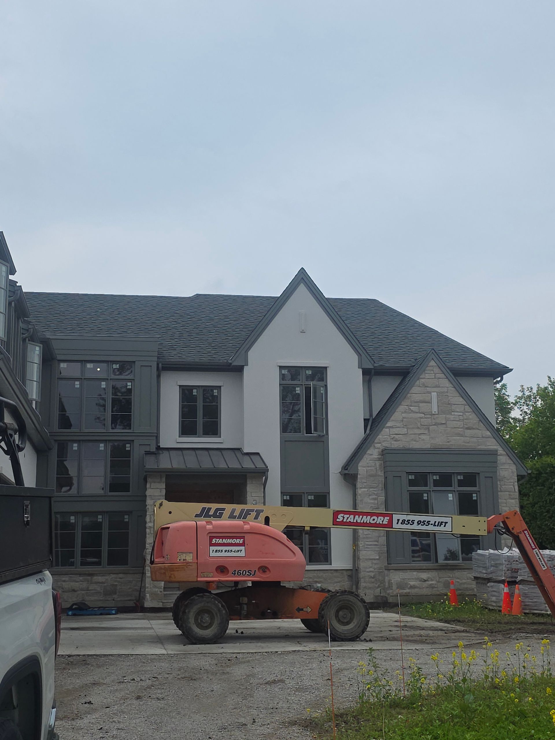 Building facade under renovation with scaffolding and a red construction lift in front