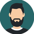 Stylized bearded avatar on a teal circular background, wearing a black shirt and white collar.