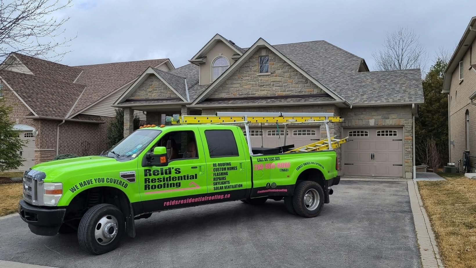 Bright green service truck parked in a suburban driveway in front of a house with a garage.