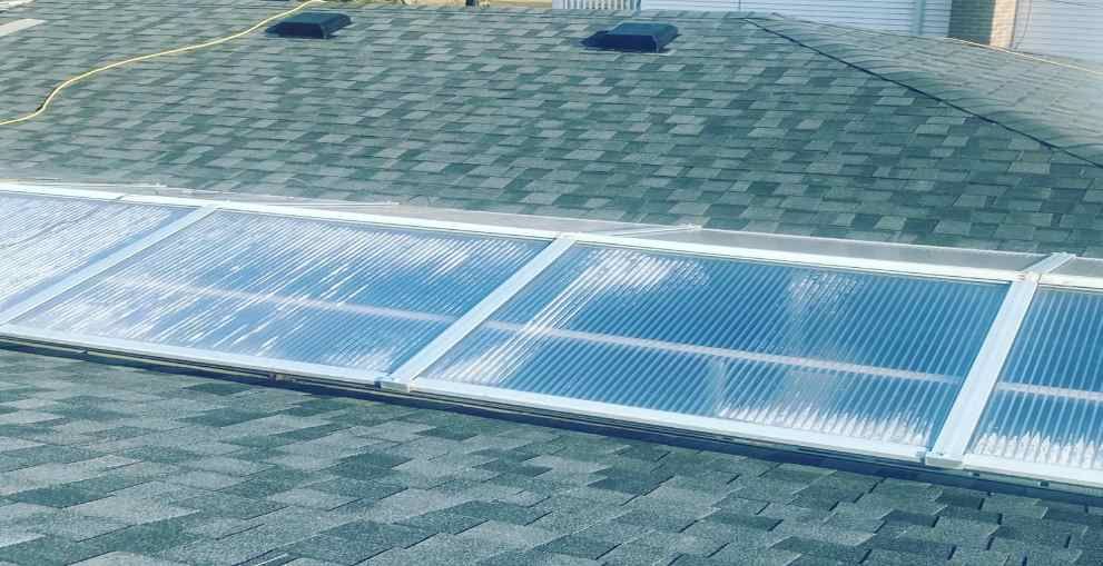 Solar panels installed on a shingled roof under daylight