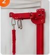 Red metal clamp mechanism with hanging loops on a white surface