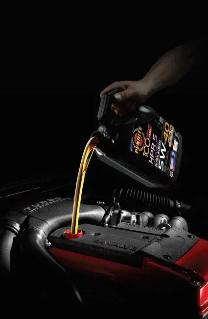 Pouring Motor Oil Into a Car Engine — Innisfail Pro Motors in Innisfail, QLD