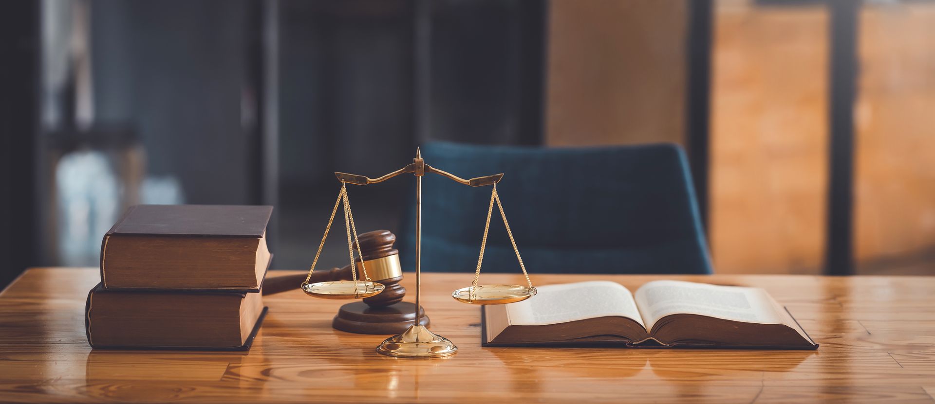 Criminal law attorney office featuring legal books, scales of justice, gavel, and law reference text.