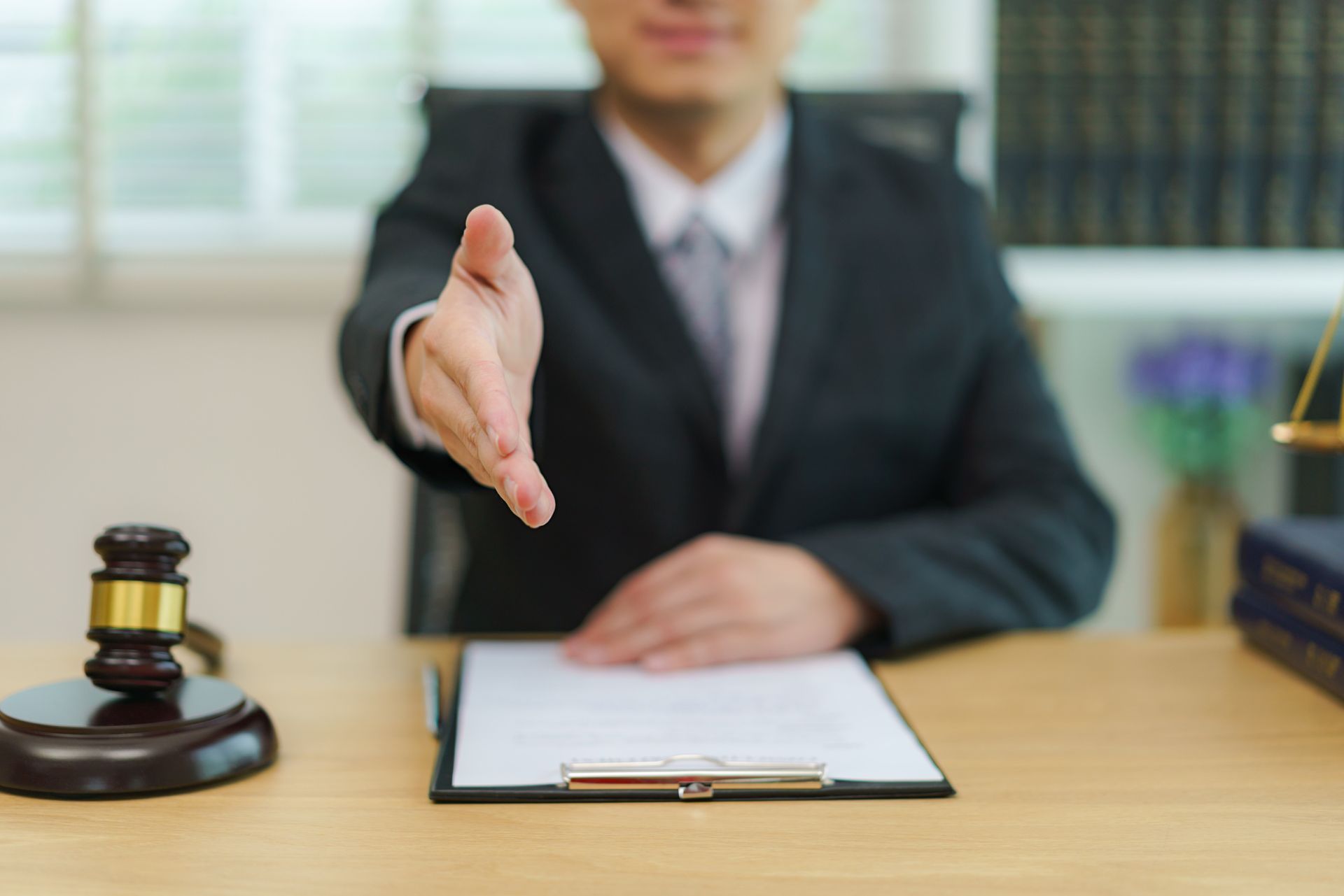 Lawyer businessman ready to shakehand to seal a deal with his partner lawyers