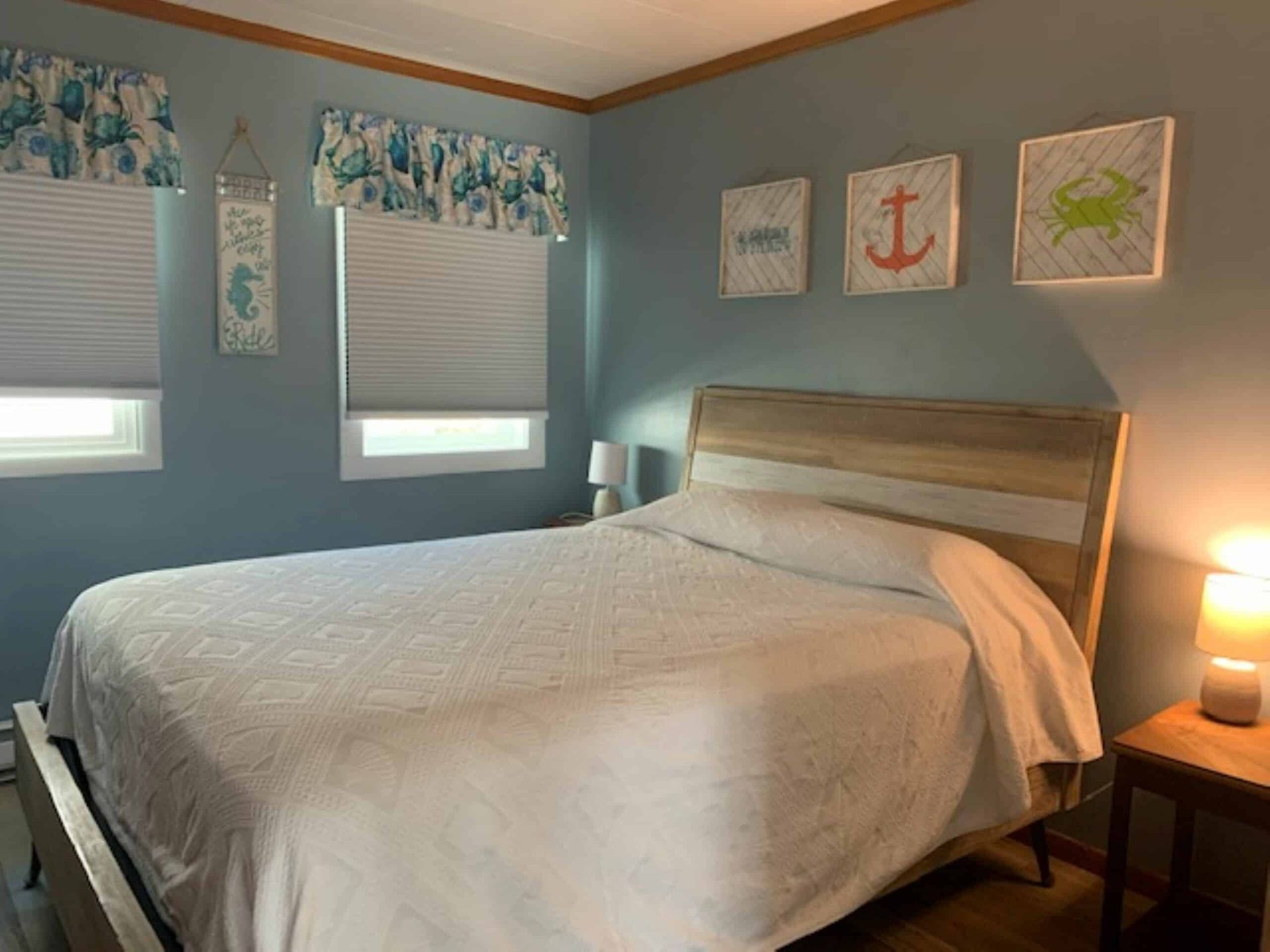 A bedroom with a bed , a nightstand , and a table.