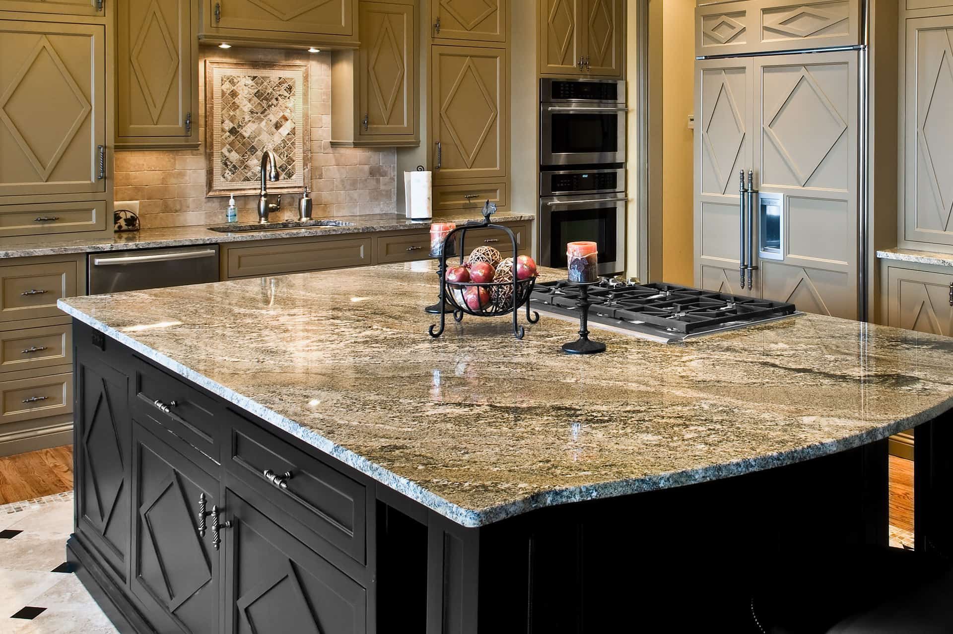 Black marble countertops paired with gold accents in a stylish kitchen.