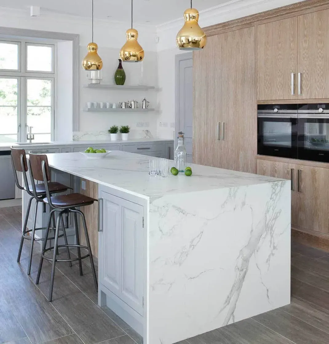 Large kitchen island with quartz countertops and seating for four.