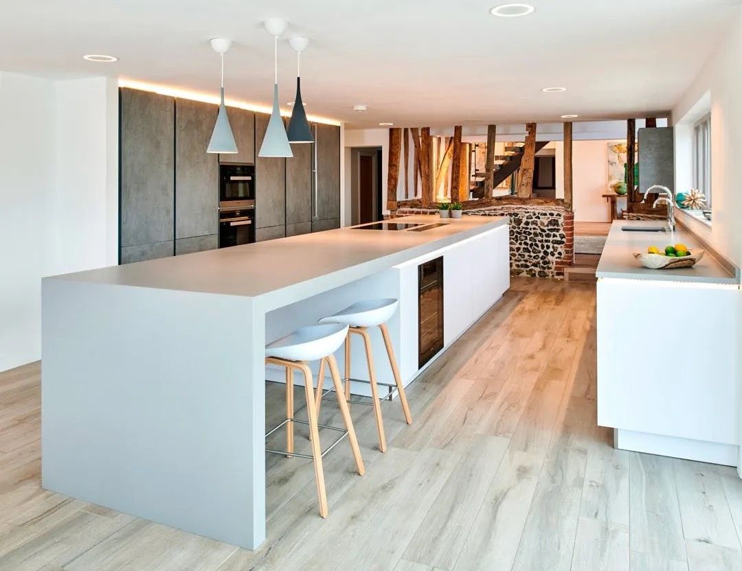 Modern kitchen featuring white quartz countertops and stainless steel appliances.