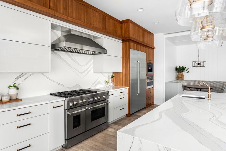 Porcelain countertops and a matching backsplash in a modern kitchen.