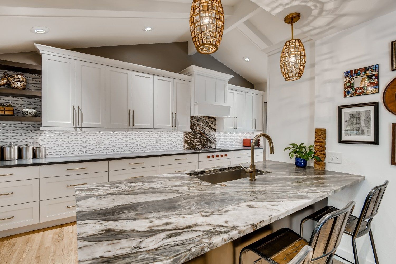 Elegant kitchen design featuring marble countertops and a large center island.
