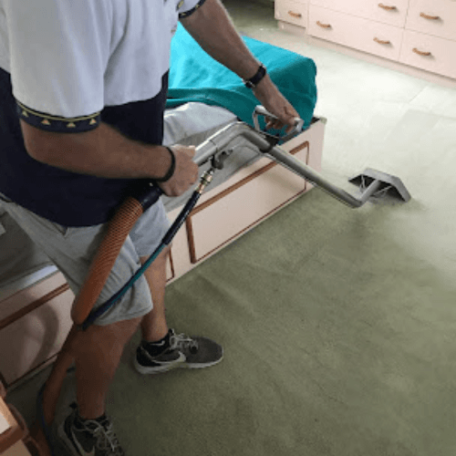 Vacuuming bedroom carpet