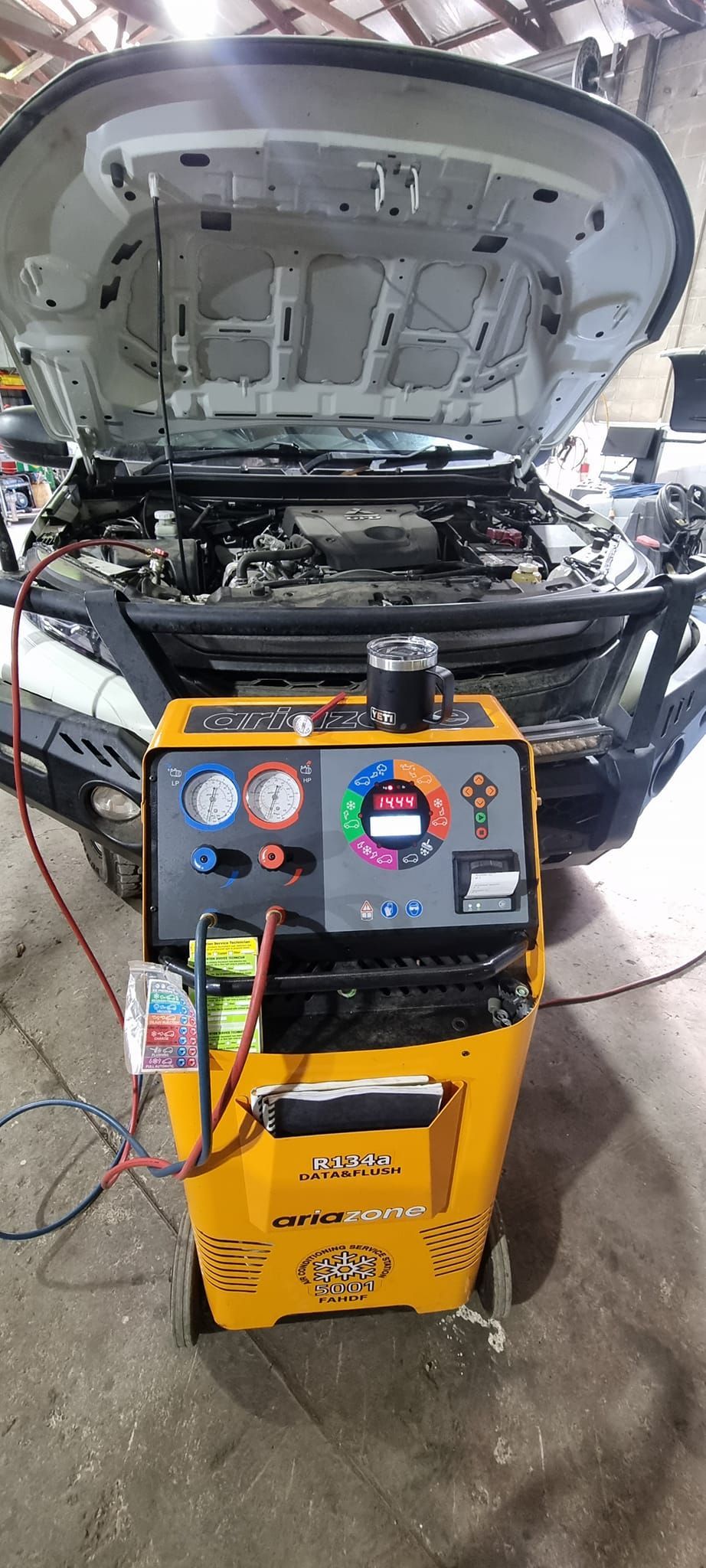 A Yellow Ac Recovery and Recharge Machine Connected to the Open Hood — B & W Commercials In Kempsey, NSW