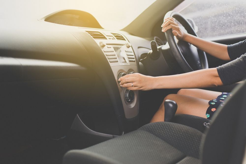 A Person Drives a Car While Adjusting the Dashboard Controls — B & W Commercials In Wauchope, NSW
